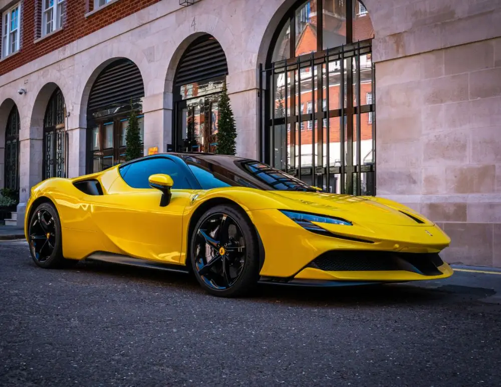 Yellow Ferrari SF90 Stradale parked on side of road