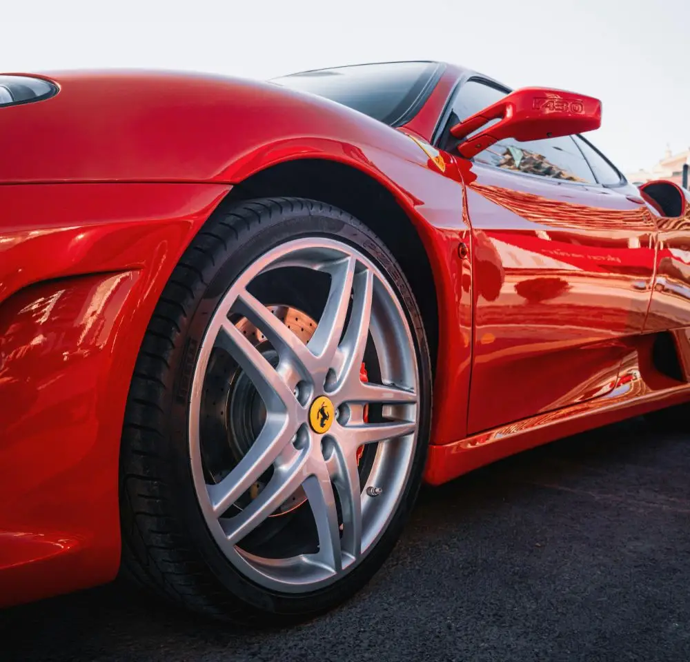 close up a wheel of a red Ferrari F430